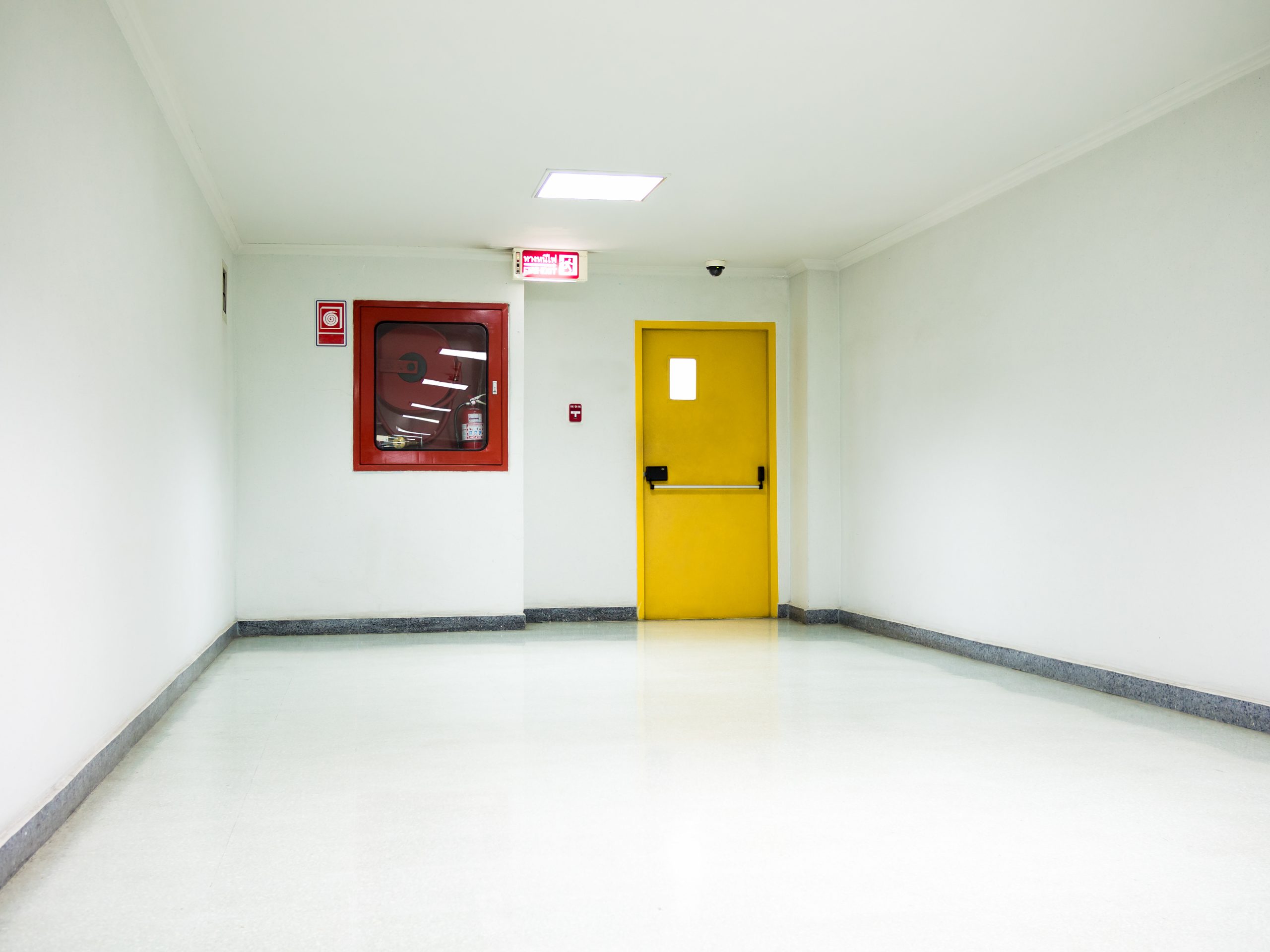 Building Emergency Exit with Exit Sign on door and Fire Extinguisher